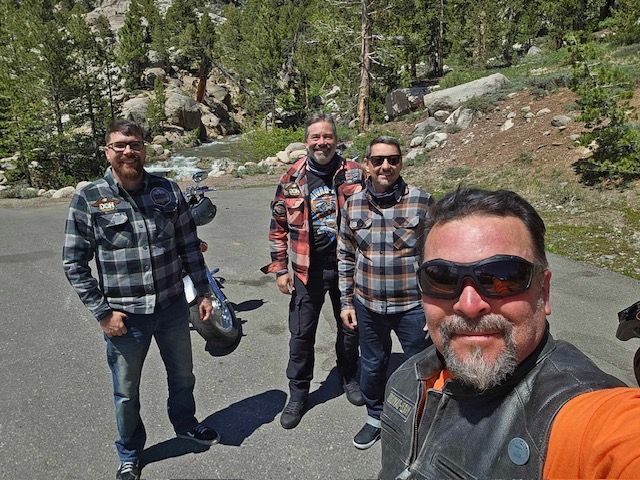 Four riders on a mountain highway in the Sierra Nevada