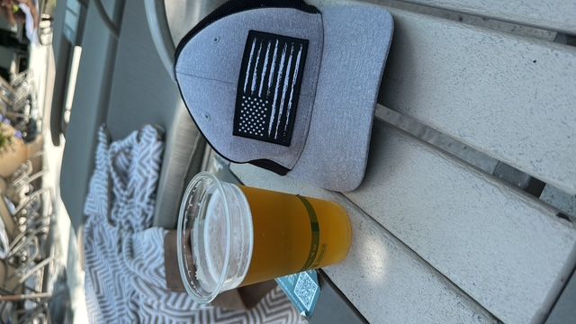 Poolside beer and a stars-and-stripes cap after a hot desert ride