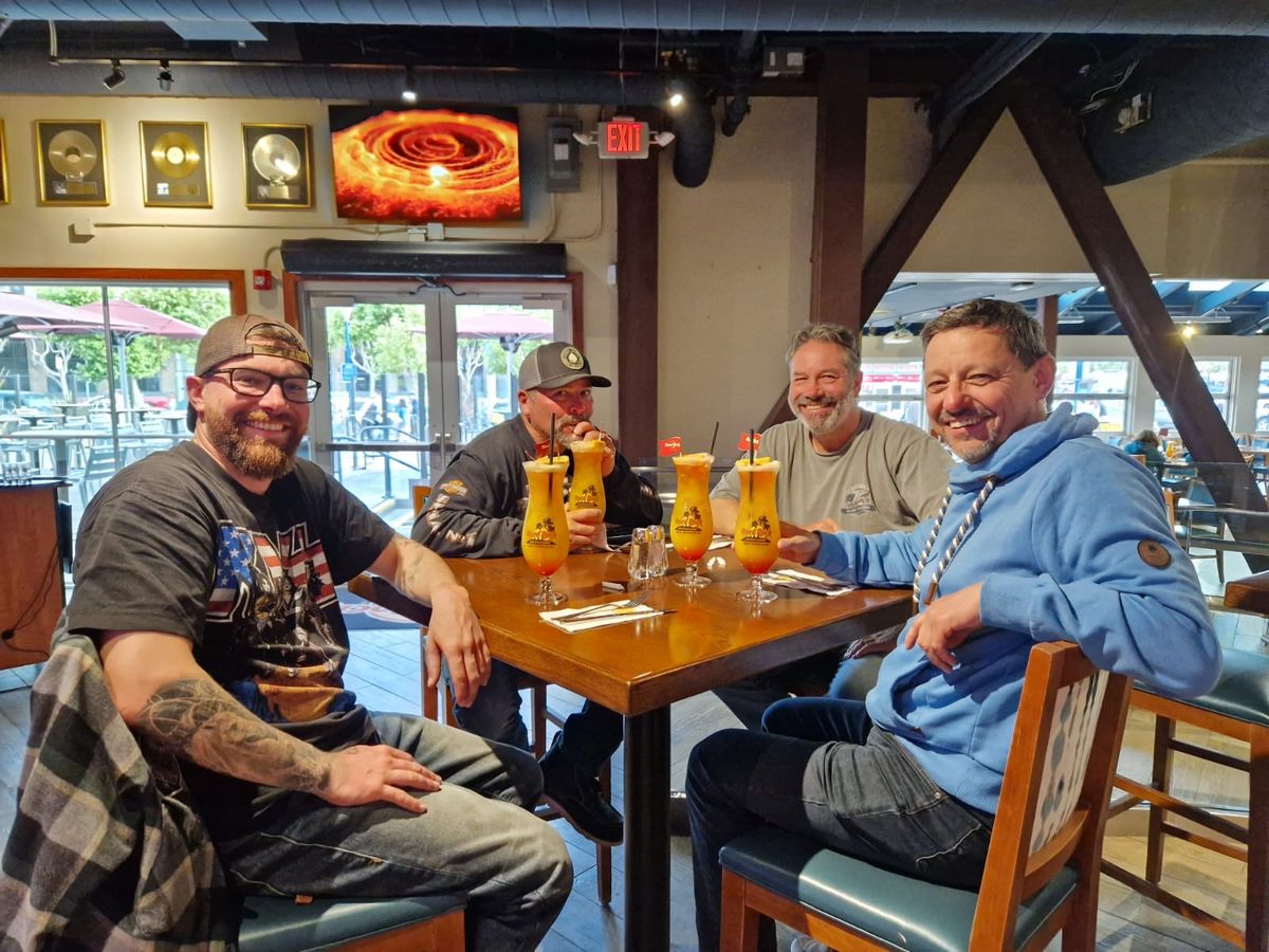 Group of riders enjoying drinks at a San Francisco bar