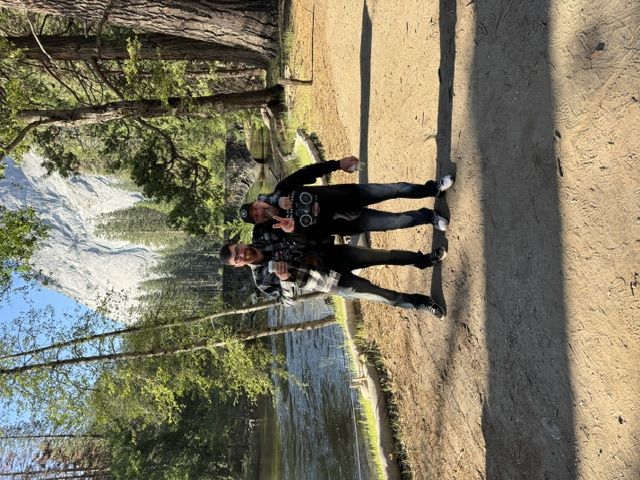 Two riders in Yosemite Valley with Half Dome in the background